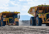 Cat is developing electric versions of large mining haul trucks like these.