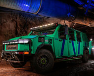 A green utility EV similar to a Hummer in an underground mine in Canada.