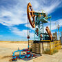 A pumpjack pumps oil from a well in an American Southwest desert.