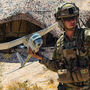 A soldier launches a small, winged Raven drone during tactical training.