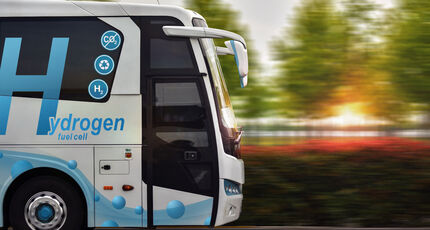 Hydrogen fuel cell bus with colorful zero emissions signage.